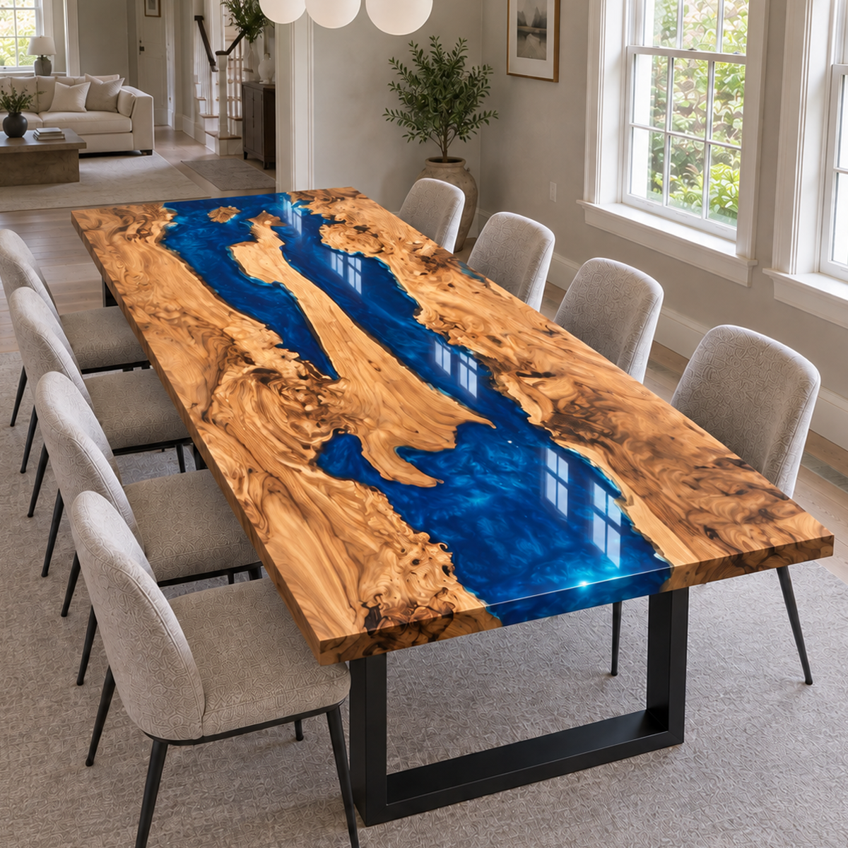 Wood dining table with a bright blue resin channel and light upholstered chairs.